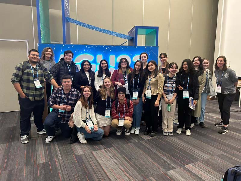 Students posing in front of AGU sign